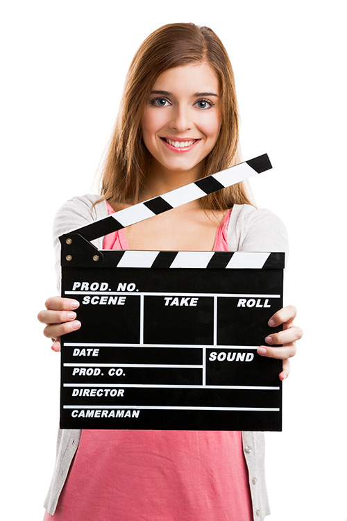 Woman holding clapperboard with smile